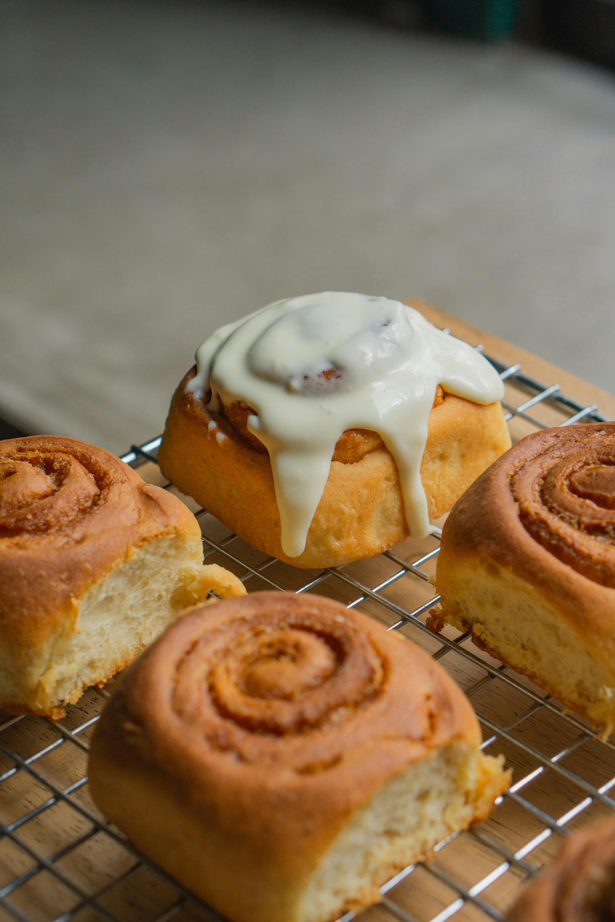 Glazed cinnamon rolls on a cooling rack